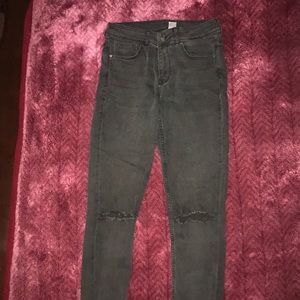 Regular black ripped jeans in the knees.